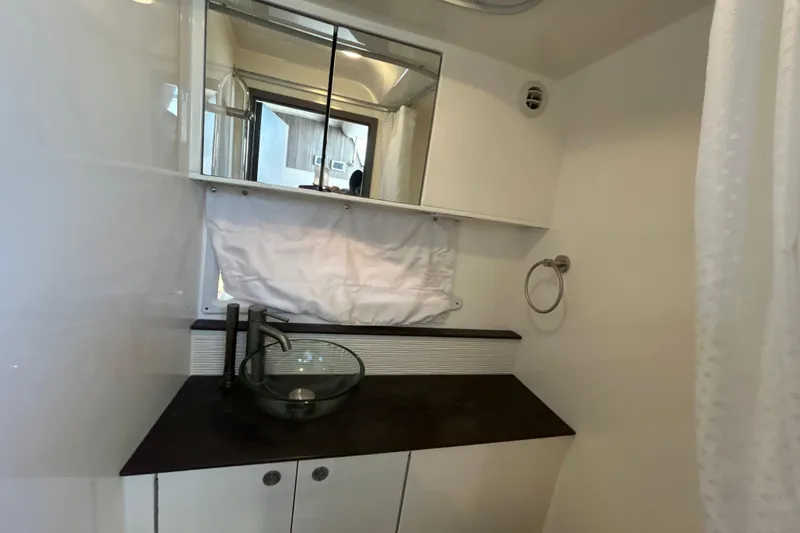 Slide: The Image of Modern bathroom interior of 2021 Sea Ray Sundancer 320 yacht with glass sink and mirror. - 15