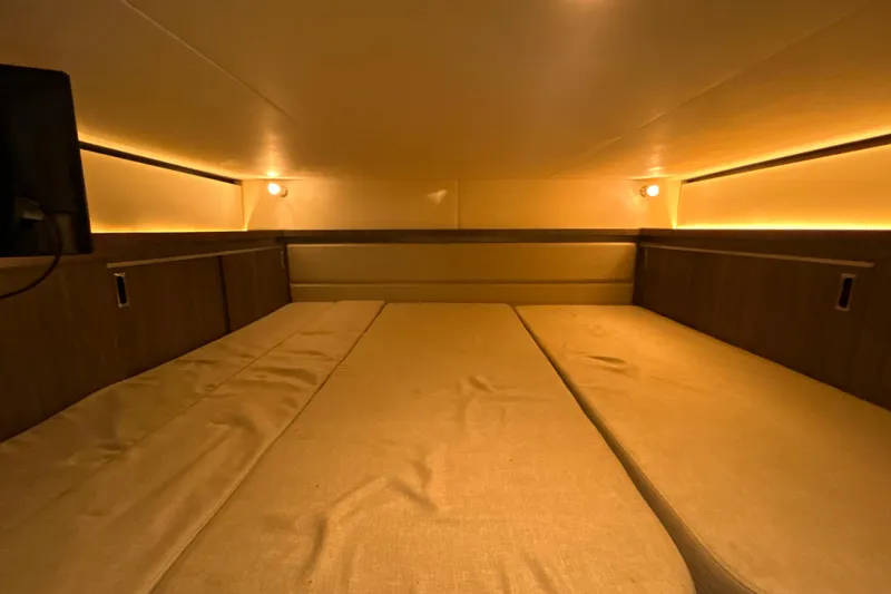 Slide: The Image of 2021 Sea Ray Sundancer 320 cabin interior with cozy lighting and comfortable seating. - 16