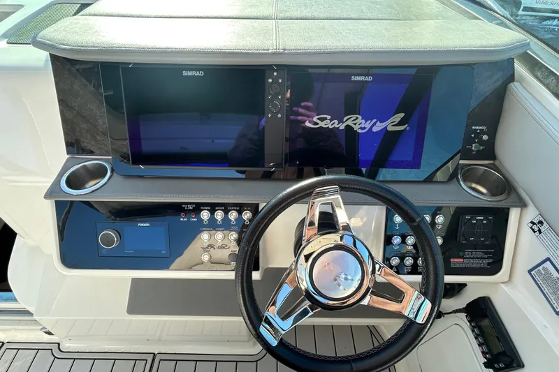 Slide: The Image of 2021 Sea Ray Sundancer 320 helm with Simrad displays and modern controls. - 7