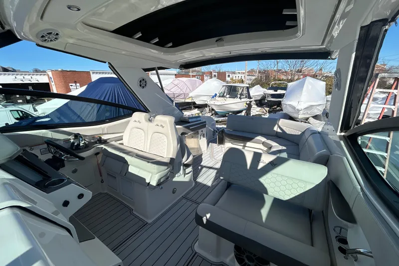 Slide: The Image of 2021 Sea Ray Sundancer 320 interior with luxurious seating and modern design. - 9