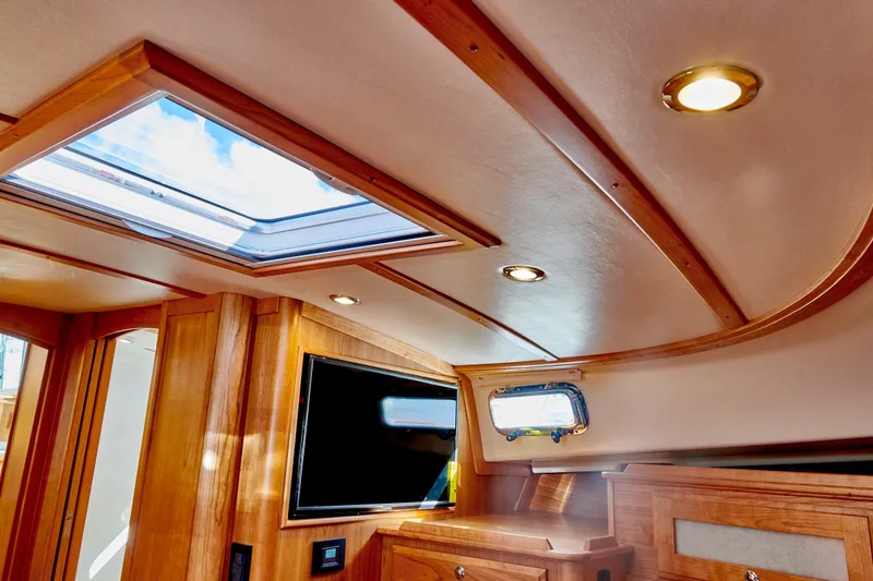 Slide: The Image of Interior of 2027 Sabre 45 Salon Express with skylights and wood finish. - 24