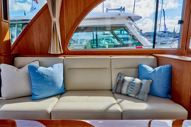 Slide: The Image of Interior of Sabre 45 Salon Express 2027 with beige sofa and blue cushions. - 5