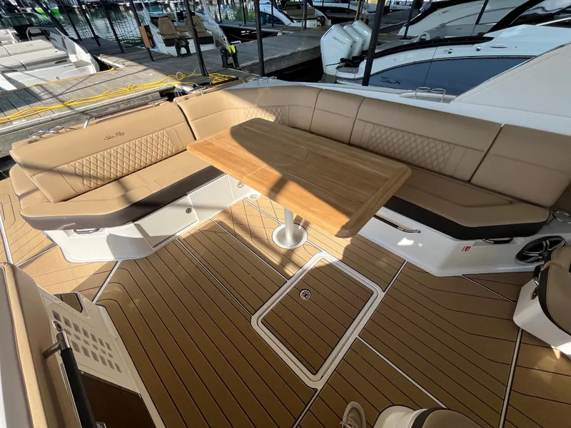 Slide: The Image of The image shows the cockpit of a 2026 Sea Ray SLX 400 with elegant seating and a wooden table. - 27