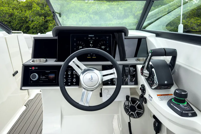 Slide: The Image of 2026 Sea Ray SDX 290 Outboard cockpit with modern controls. - 11