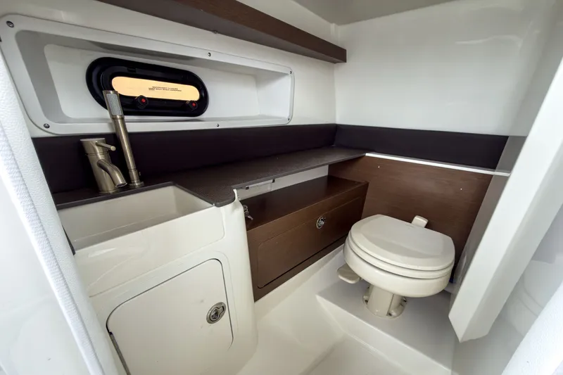 Slide: The Image of Interior of 2026 Sea Ray SDX 290 Outboard with toilet and sink. - 15
