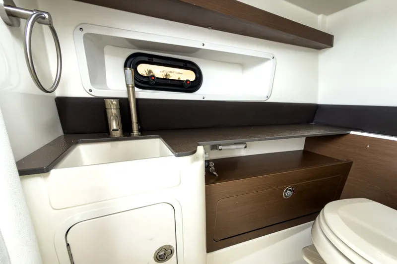 Slide: The Image of Interior of 2026 Sea Ray SDX 290 Outboard with sink and storage. - 16