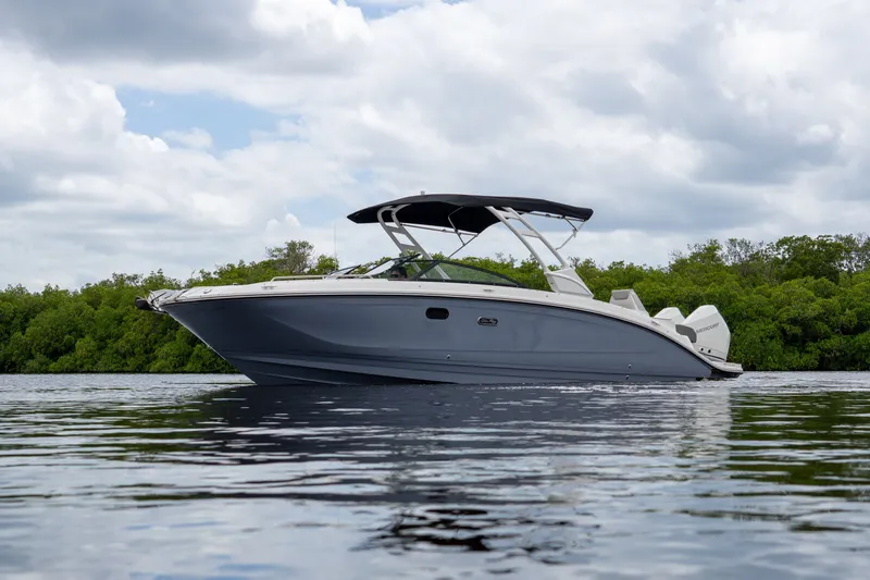 Slide: The Image of 2026 Sea Ray SDX 290 Outboard on calm water. - 2