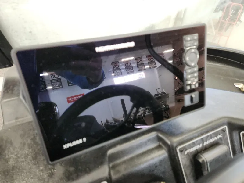 Slide: The Image of 2025 Crestliner 1850 Fish Hawk WT with modern control console. - 11