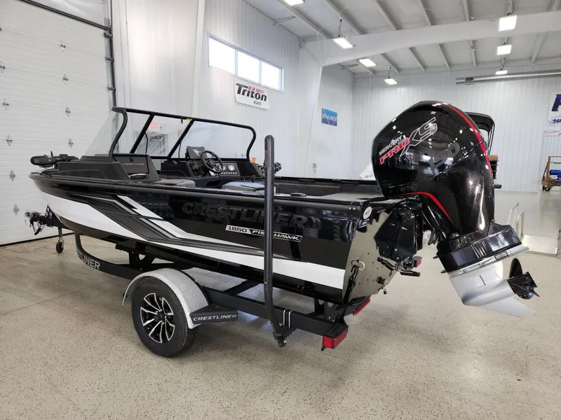 Slide: The Image of 2025 Crestliner 1850 Fish Hawk WT boat in a showroom. - 4