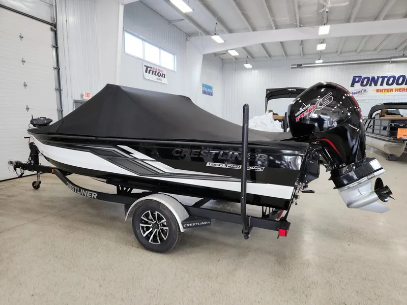 Slide: The Image of 2025 Crestliner 1850 Fish Hawk WT boat in warehouse. - 5