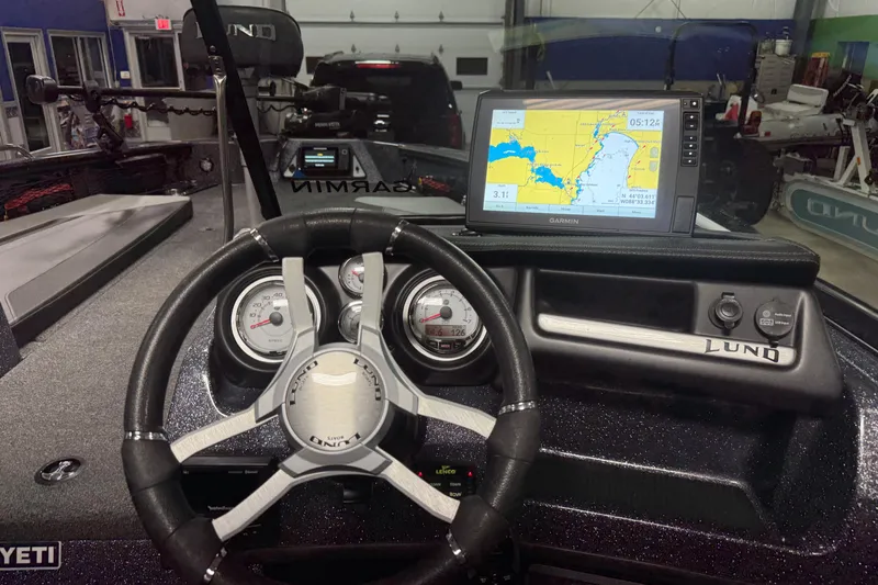 Slide: The Image of 2022 Lund 202 Pro-V GL boat dashboard with Garmin GPS and steering wheel. - 12