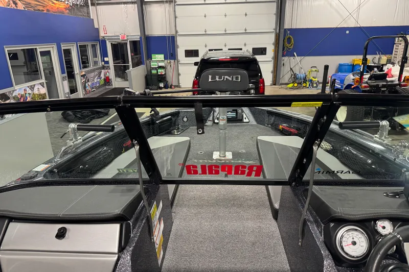 Slide: The Image of 2022 Lund 202 Pro-V GL boat interior in a showroom with equipment and accessories. - 16