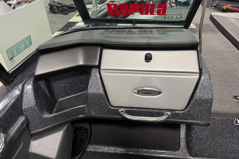 Slide: The Image of 2022 Lund 202 Pro-V GL boat interior with storage compartment and Rapala branding. - 17