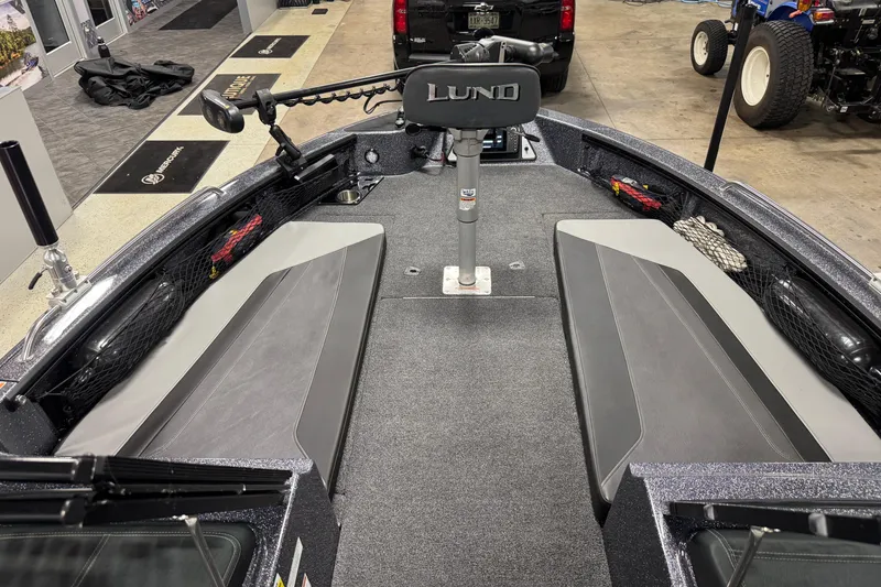 Slide: The Image of 2022 Lund 202 Pro-V GL boat interior with seating and steering console. - 18
