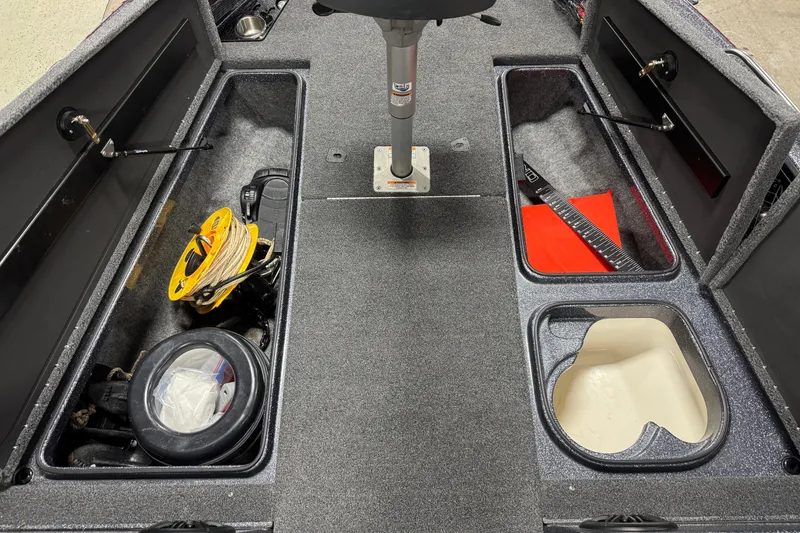 Slide: The Image of 2022 Lund 202 Pro-V GL boat interior with storage compartments and fishing gear. - 22