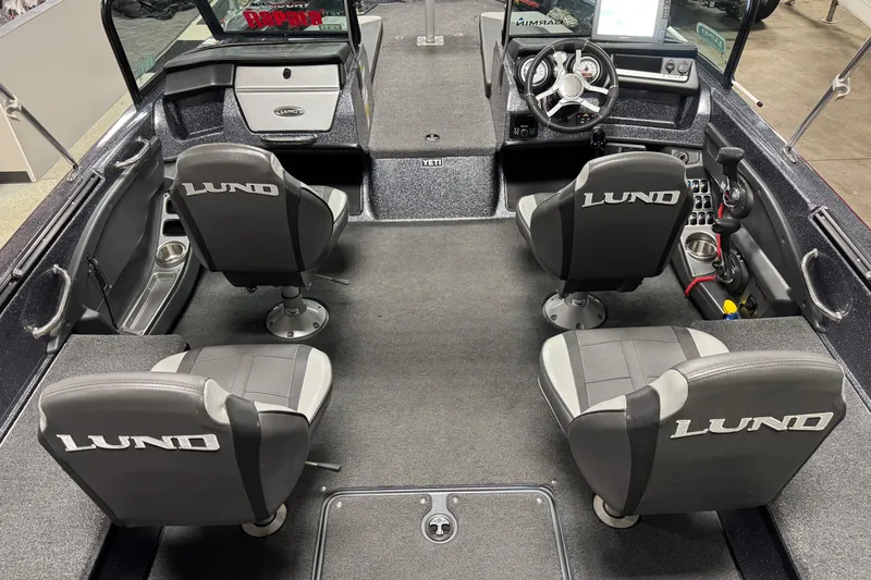Slide: The Image of 2022 Lund 202 Pro-V GL boat interior with four seats and modern dashboard. - 28