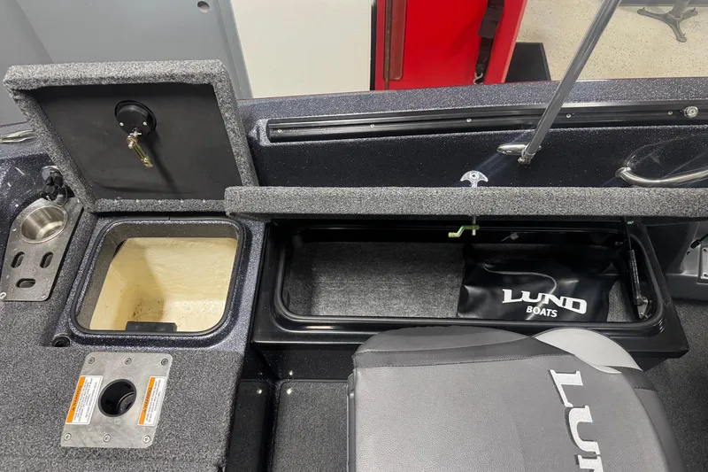 Slide: The Image of 2022 Lund 202 Pro-V GL boat interior with storage compartments and seating. - 7