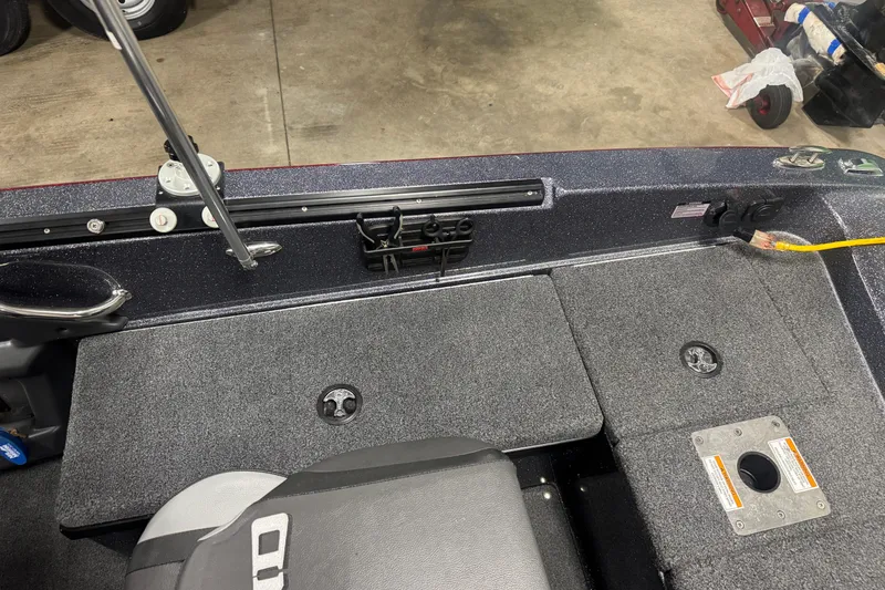 Slide: The Image of 2022 Lund 202 Pro-V GL boat interior with storage compartments and seating. - 8