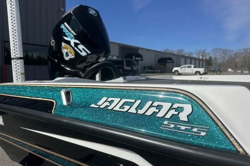 Slide: The Image of 2026 Bass Cat Jaguar STS boat with glittery teal finish and powerful engine. - 2