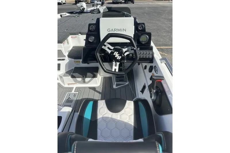 Slide: The Image of 2026 Bass Cat Jaguar STS boat cockpit with Garmin navigation system and modern steering wheel. - 7