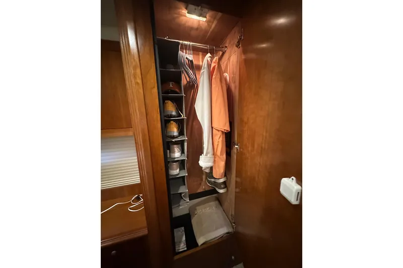 Slide: The Image of Closet interior of 2008 Cruisers Yachts 415 Express Motoryacht with hanging clothes and shoe organizer. - 12
