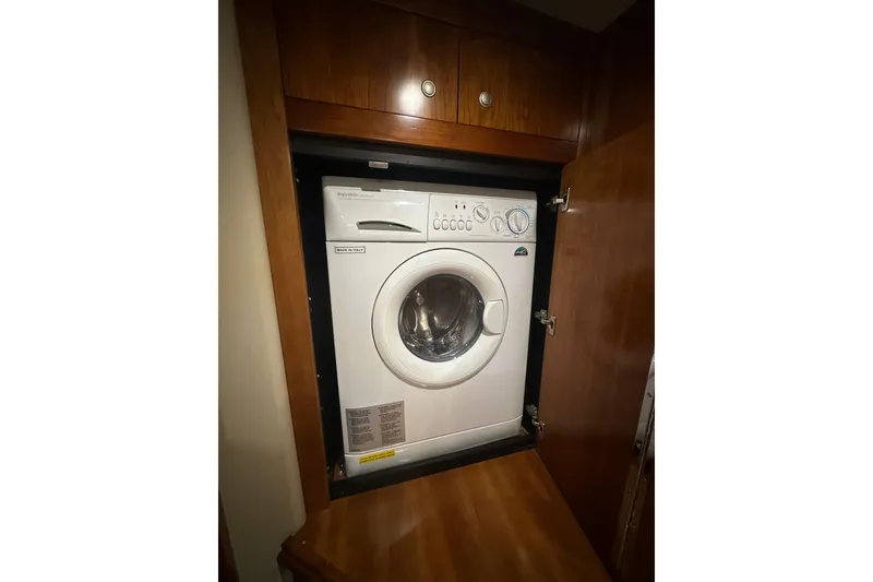 Slide: The Image of 2008 Cruisers Yachts 415 Express Motoryacht with built-in washing machine in wooden cabinet. - 16