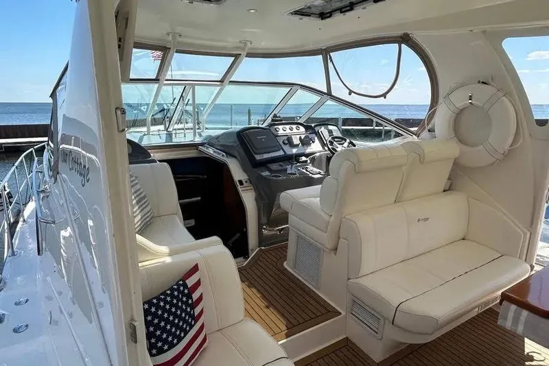 Slide: The Image of 2008 Cruisers Yachts 415 Express Motoryacht interior with ocean view and American flag pillow. - 2