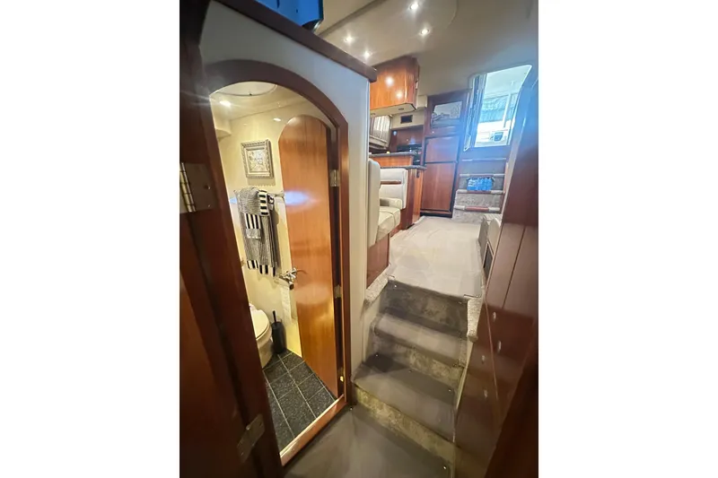 Slide: The Image of Interior of 2008 Cruisers Yachts 415 Express Motoryacht, featuring stairs, bathroom, and seating area. - 20