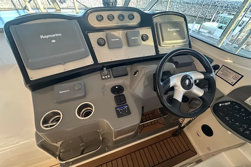 Slide: The Image of 2008 Cruisers Yachts 415 Express Motoryacht helm with Raymarine navigation equipment. - 21
