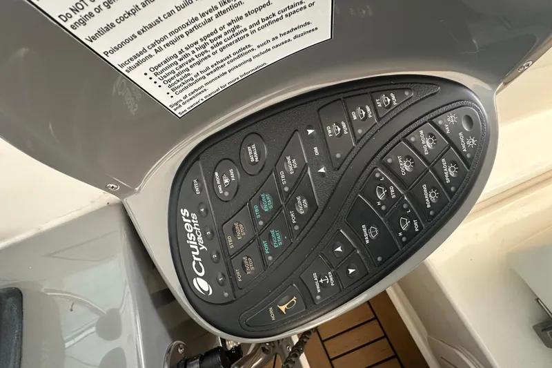 Slide: The Image of Control panel of 2008 Cruisers Yachts 415 Express Motoryacht with various switches and labels. - 28