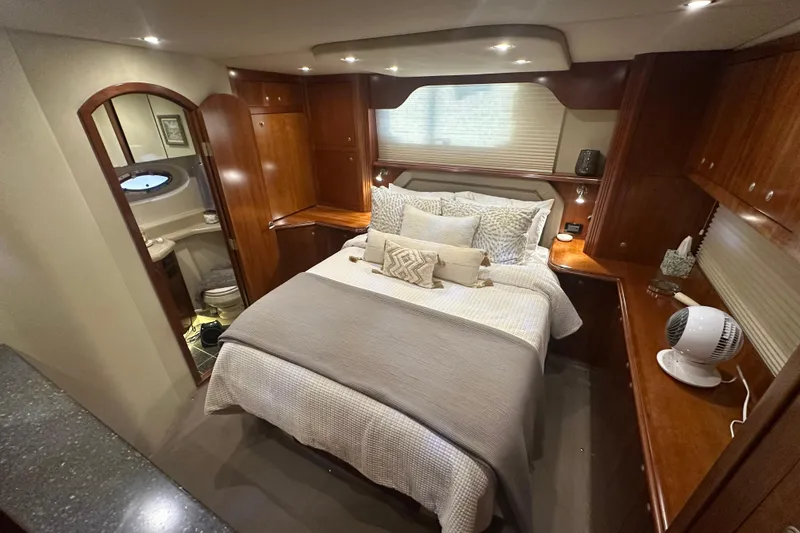 Slide: The Image of Luxurious 2008 Cruisers Yachts 415 Express Motoryacht bedroom with elegant wood finishes. - 10