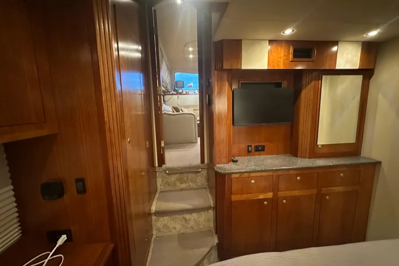 Slide: The Image of Interior of 2008 Cruisers Yachts 415 Express Motoryacht with wood cabinetry and TV. - 13