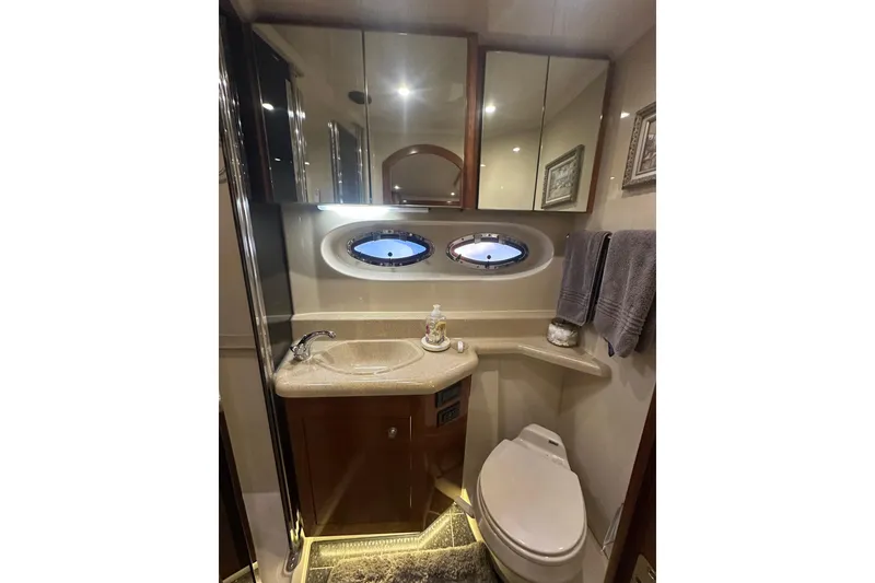 Slide: The Image of Luxurious bathroom in 2008 Cruisers Yachts 415 Express Motoryacht with elegant fixtures and porthole windows. - 14