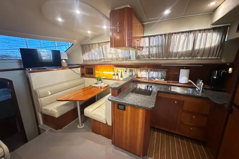 Slide: The Image of Luxurious 2008 Cruisers Yachts 415 Express Motoryacht interior with kitchen and dining area. - 7