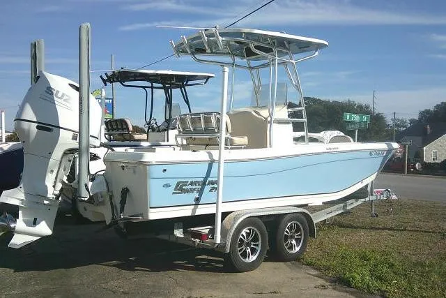 Slide: The Image of 2022 Carolina Skiff 21 Ultra Elite boat on trailer, featuring dual engines. - 16
