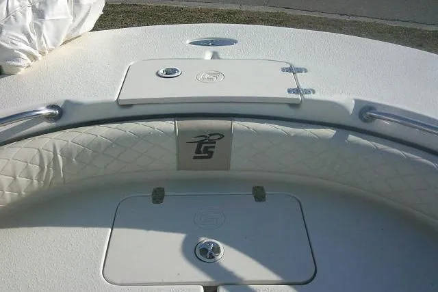 Slide: The Image of 2022 Carolina Skiff 21 Ultra Elite boat deck with storage compartments and cushioned seating. - 23