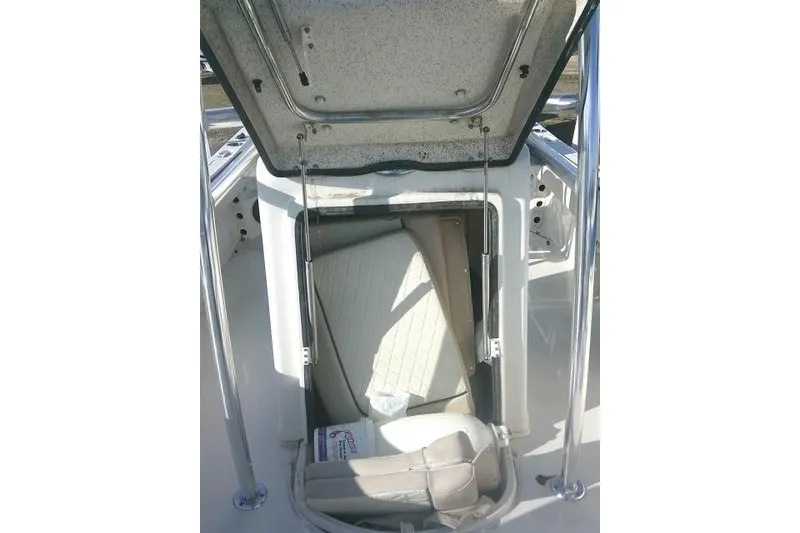Slide: The Image of 2022 Carolina Skiff 21 Ultra Elite boat storage compartment open. - 26