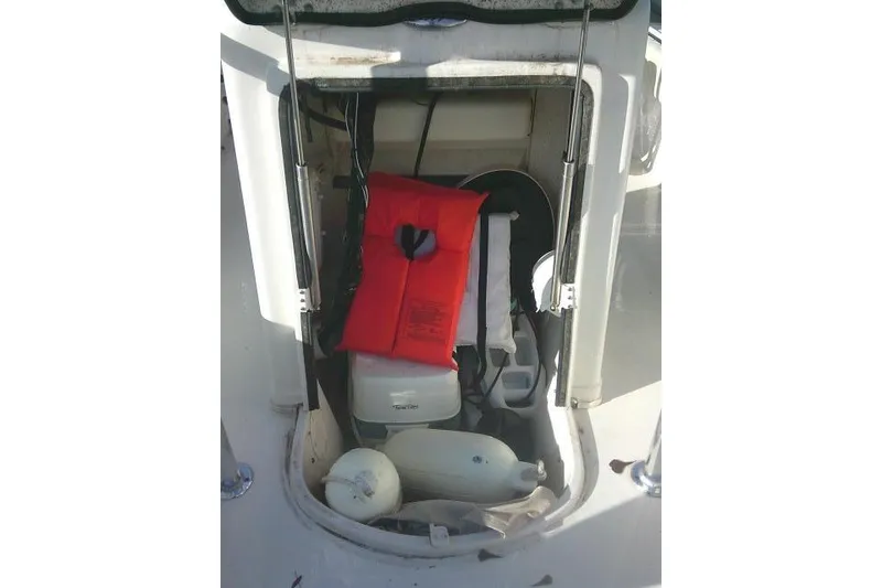 Slide: The Image of Storage compartment of 2022 Carolina Skiff 21 Ultra Elite with life jacket and equipment. - 28