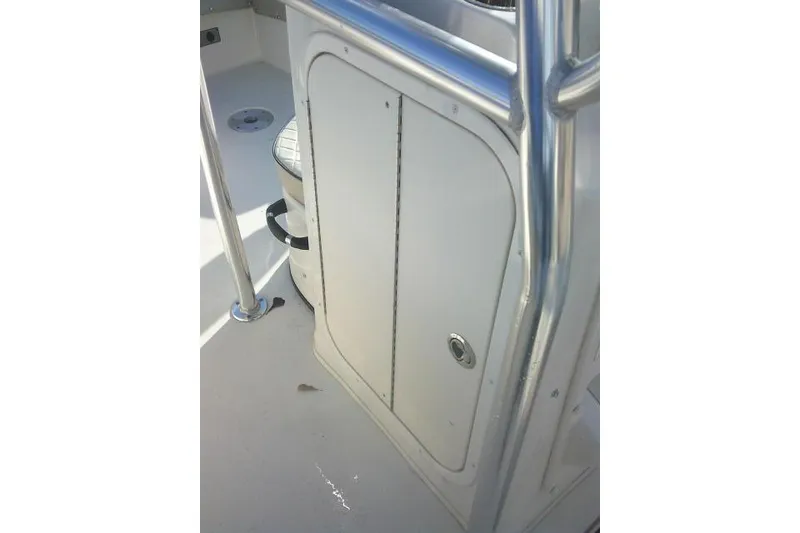 Slide: The Image of 2022 Carolina Skiff 21 Ultra Elite boat interior with storage compartment and railing. - 43