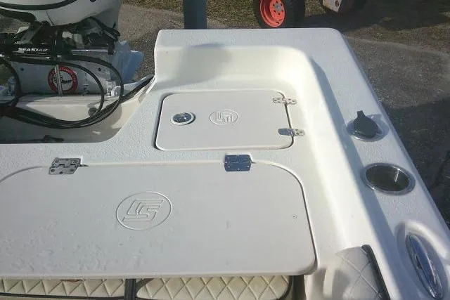 Slide: The Image of 2022 Carolina Skiff 21 Ultra Elite boat deck with storage compartments and motor. - 51