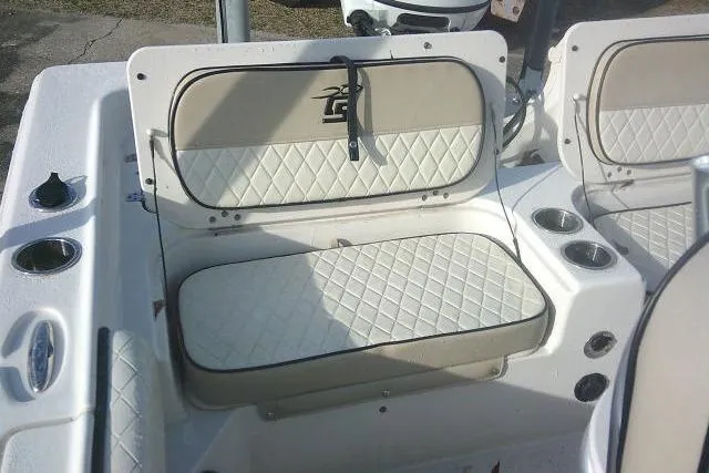 Slide: The Image of 2022 Carolina Skiff 21 Ultra Elite boat seating with cup holders and storage. - 52