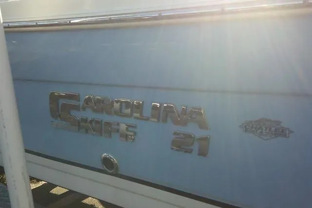 Slide: The Image of 2022 Carolina Skiff 21 Ultra Elite boat side view with sunlight reflection. - 9