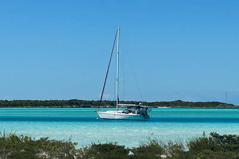 Slide: The Image of Sailboat Catalina 42 MkII 1999 anchored in turquoise waters under clear blue sky. - 1