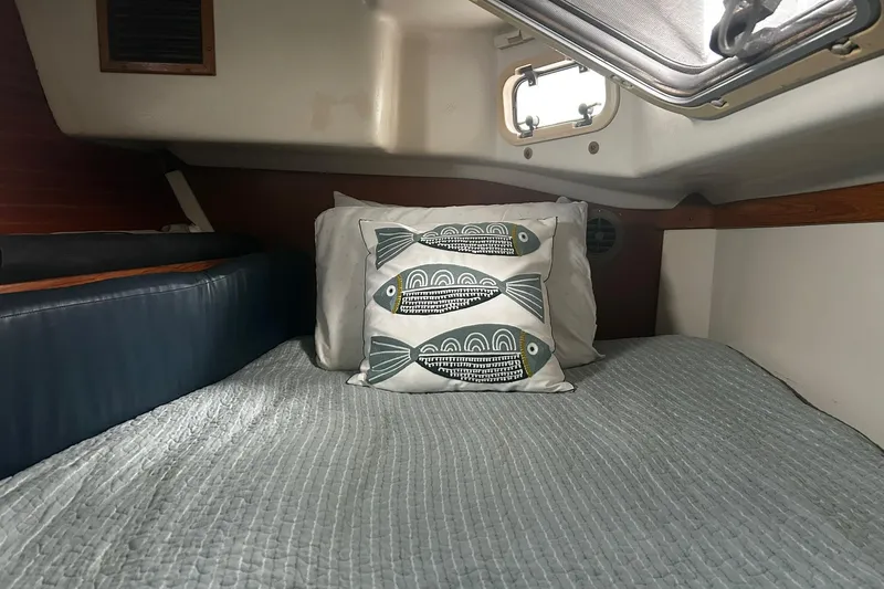 Slide: The Image of Cozy cabin interior of 1999 Catalina 42 MkII sailboat with fish-themed pillow. - 11