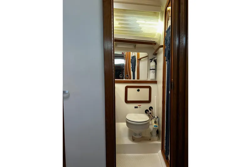 Slide: The Image of Bathroom interior of 1999 Catalina 42 MkII yacht, featuring compact design and wooden accents. - 16
