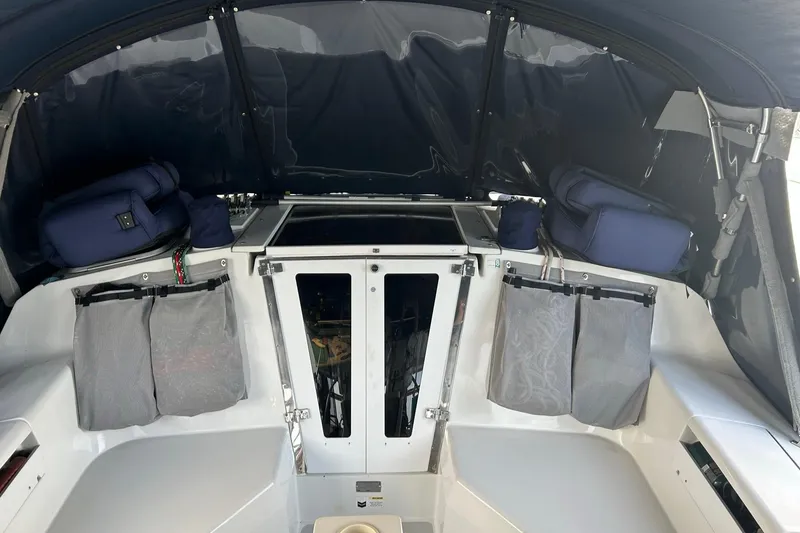 Slide: The Image of Interior of a 1999 Catalina 42 MkII sailboat cockpit with blue cushions and storage. - 18
