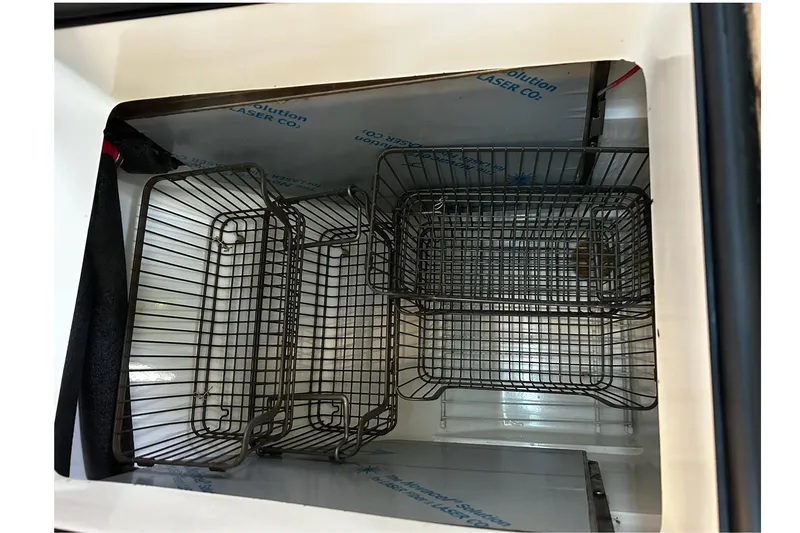 Slide: The Image of Storage compartment with wire baskets in a 1999 Catalina 42 MkII sailboat. - 23