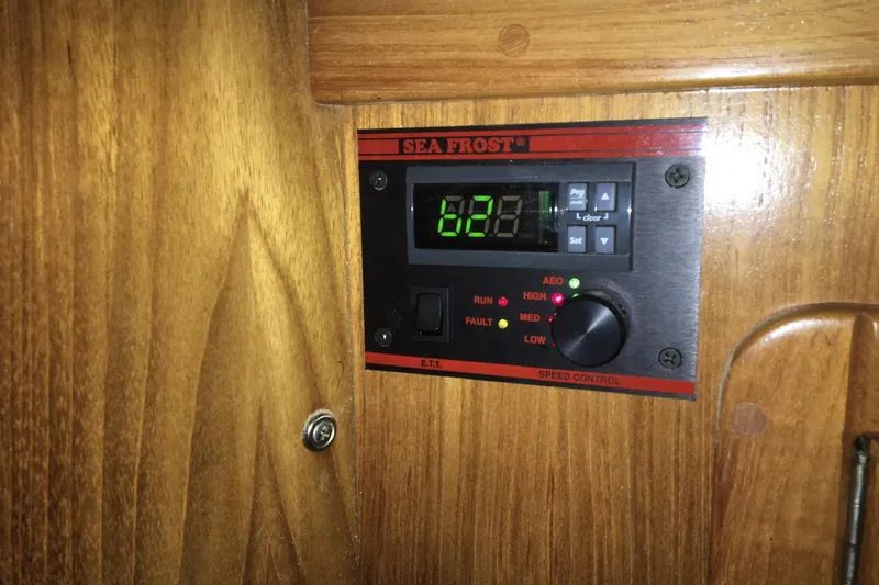 Slide: The Image of Sea Frost control panel on 1999 Catalina 42 MkII yacht, mounted on wooden surface. - 24