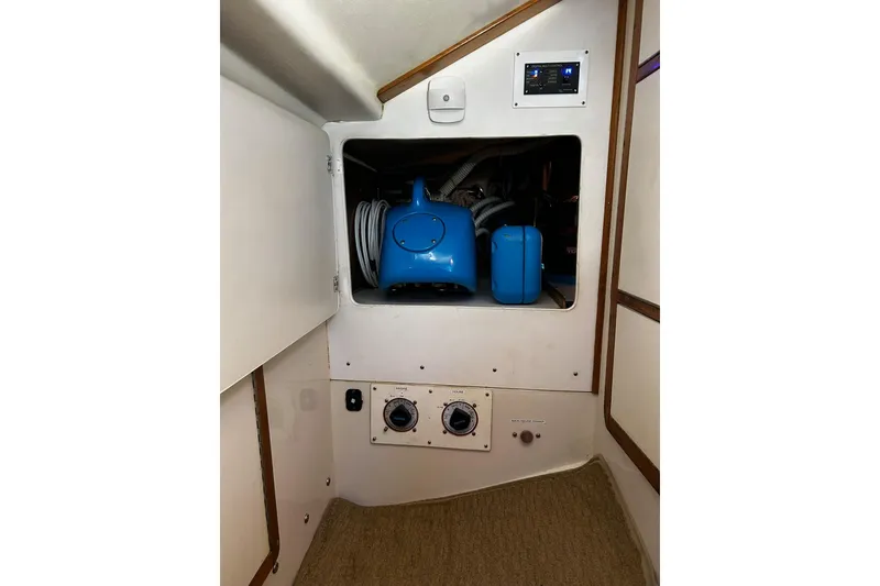Slide: The Image of Interior view of a 1999 Catalina 42 MkII sailboat showing storage compartment and equipment. - 26