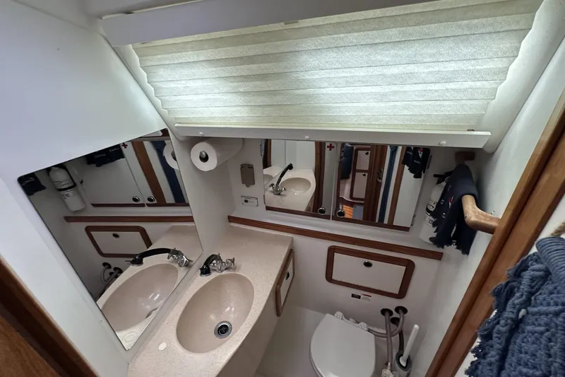 Slide: The Image of Bathroom interior of a 1999 Catalina 42 MkII yacht with sink and toilet. - 44